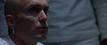 Movie still from “THX 1138” (1971), directed by George Lucas – A man's face in a dark room; Close Up shot, Low angle