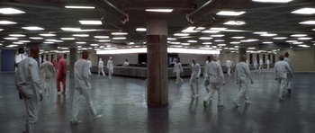 Movie still from “THX 1138” (1971), directed by George Lucas – A group of people walking in a room; Extreme Wide shot, High angle