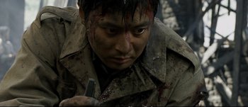 Movie still from “Tae Guk Gi: The Brotherhood of War” (2004), directed by Kang Je-kyu – A person with blood on his face; Close Up shot, High angle