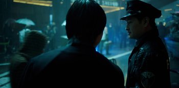 Two people in a dark room talking to each other