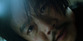 Movie still from “Altered Carbon” (2018), created by Laeta Kalogridis – A man's face with green eyes; Extreme Close Up shot, Low angle