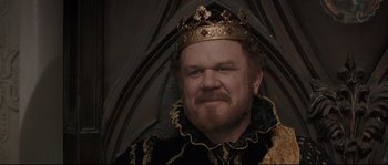 Movie still from “Tale of Tales” (2015), directed by Matteo Garrone – A man with a beard wearing a gold crown; Close Up shot, High angle