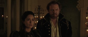 Movie still from “Tale of Tales” (2015), directed by Matteo Garrone – A man and a woman standing next to each other in front of candles; Close Up shot, Over the shoulder angle
