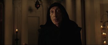 Movie still from “Tale of Tales” (2015), directed by Matteo Garrone – An old man in a black hooded cloak; Close Up shot, Low angle