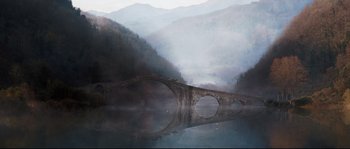Movie still from “Tale of Tales” (2015), directed by Matteo Garrone – A bridge that is in the middle of a lake; Extreme Wide shot, High angle