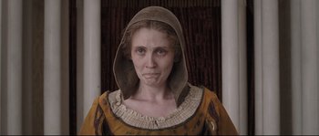 Movie still from “Tale of Tales” (2015), directed by Matteo Garrone – A woman in a brown dress and a brown hat; Close Up shot, Low angle