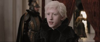 Movie still from “Tale of Tales” (2015), directed by Matteo Garrone – A man with white hair and a black jacket; Close Up shot, High angle