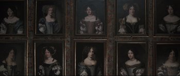 Movie still from “Tale of Tales” (2015), directed by Matteo Garrone – A group of six paintings of women are hanging on a wall; Medium shot, Low angle