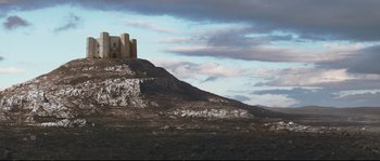 Movie still from “Tale of Tales” (2015), directed by Matteo Garrone – A castle on top of a hill under a cloudy sky; Extreme Wide shot, Low angle