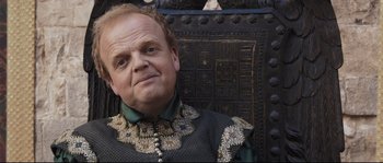 Movie still from “Tale of Tales” (2015), directed by Matteo Garrone – A person sitting on a chair; Close Up shot, Over the shoulder angle