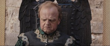 Movie still from “Tale of Tales” (2015), directed by Matteo Garrone – A person sitting on a chair; Close Up shot, High angle