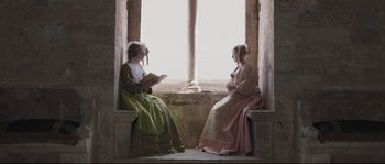 Movie still from “Tale of Tales” (2015), directed by Matteo Garrone – Two young women are sitting in front of a window; Medium shot, High angle