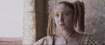 Movie still from “Tale of Tales” (2015), directed by Matteo Garrone – A woman with blonde hair and a pearl necklace; Close Up shot, Low angle