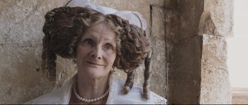 Movie still from “Tale of Tales” (2015), directed by Matteo Garrone – An older woman with a cat on her head; Close Up shot, Over the shoulder angle