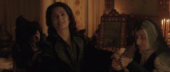 Movie still from “Tale of Tales” (2015), directed by Matteo Garrone – A woman is smiling in front of a mirror; Medium shot, Over the shoulder angle