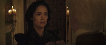 Movie still from “Tale of Tales” (2015), directed by Matteo Garrone – A person wearing a suit and tie; Close Up shot, Over the shoulder angle