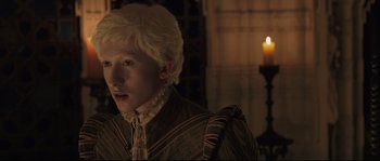 Movie still from “Tale of Tales” (2015), directed by Matteo Garrone – A young man with blonde hair and a white wig; Close Up shot, High angle