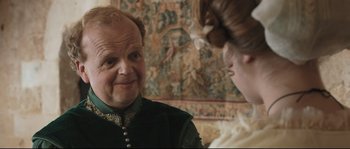 Movie still from “Tale of Tales” (2015), directed by Matteo Garrone – An older man and a young woman are talking to each other; Close Up shot, Over the shoulder angle