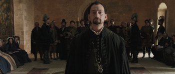 Movie still from “Tale of Tales” (2015), directed by Matteo Garrone – A man standing in front of a group of people; Medium shot, Over the shoulder angle