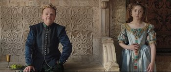 Movie still from “Tale of Tales” (2015), directed by Matteo Garrone – A man and a woman standing next to each other in front of a stone wall; Medium shot, Over the shoulder angle