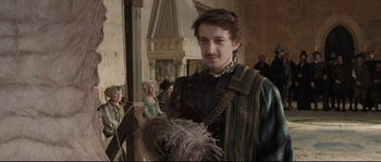 Movie still from “Tale of Tales” (2015), directed by Matteo Garrone – A man with a feather in his hair; Medium shot, Over the shoulder angle