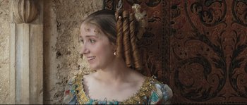 Movie still from “Tale of Tales” (2015), directed by Matteo Garrone – A young woman with a long , blonde hair style; Close Up shot, Over the shoulder angle