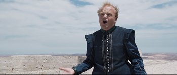 Movie still from “Tale of Tales” (2015), directed by Matteo Garrone – A man in a medieval garb with his mouth wide open; Medium shot, Low angle