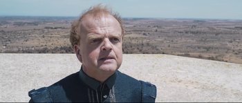Movie still from “Tale of Tales” (2015), directed by Matteo Garrone – An older man with a beard and a mustache; Close Up shot, Over the shoulder angle