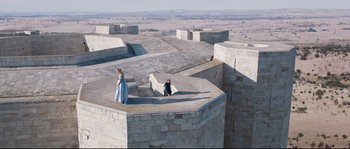 Movie still from “Tale of Tales” (2015), directed by Matteo Garrone – Two people are standing on the top of a building; Extreme Wide shot, High angle