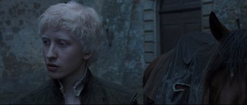 Movie still from “Tale of Tales” (2015), directed by Matteo Garrone – Two people standing next to each other near a building; Close Up shot, Over the shoulder angle