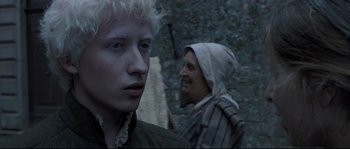 Movie still from “Tale of Tales” (2015), directed by Matteo Garrone – A man and a woman standing next to each other; Close Up shot, Over the shoulder angle