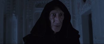 Movie still from “Tale of Tales” (2015), directed by Matteo Garrone – An old man wearing a black robe and a black hood; Close Up shot, Low angle