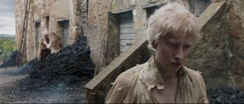 Movie still from “Tale of Tales” (2015), directed by Matteo Garrone – A man with white hair is standing in a alley; Close Up shot, High angle