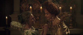 Movie still from “Tale of Tales” (2015), directed by Matteo Garrone – Two women dressed in renaissance clothing holding each other; Close Up shot, Over the shoulder angle
