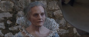 Movie still from “Tale of Tales” (2015), directed by Matteo Garrone – An old woman with a silver dress and a white wig; Close Up shot, Over the shoulder angle