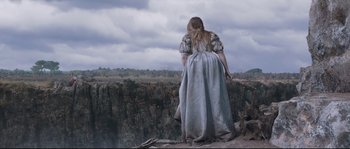 Movie still from “Tale of Tales” (2015), directed by Matteo Garrone – A woman standing on top of a cliff looking out over a valley; Extreme Wide shot, Overhead angle
