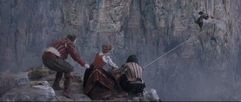 Movie still from “Tale of Tales” (2015), directed by Matteo Garrone – A group of people sitting on top of a cliff; Wide shot, High angle