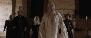 Movie still from “Tale of Tales” (2015), directed by Matteo Garrone – A man wearing a white shirt and a beard; Medium shot, Low angle