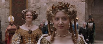 Movie still from “Tale of Tales” (2015), directed by Matteo Garrone – A woman in a renaissance costume with a crown on her head; Close Up shot, Over the shoulder angle