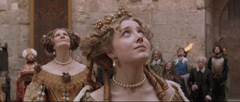 Movie still from “Tale of Tales” (2015), directed by Matteo Garrone – A woman in a renaissance dress looking upward; Close Up shot, Low angle