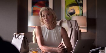 Movie still from “Ted Lasso” (2020), created by Brendan Hunt – A woman sitting at a table with a laptop in front of her; Medium shot, Low angle
