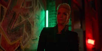 Movie still from “Ted Lasso” (2020), created by Brendan Hunt – A woman standing in front of a green lit wall; Close Up shot, Low angle