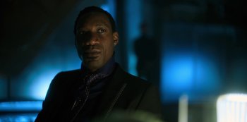 Movie still from “Altered Carbon” (2018), created by Laeta Kalogridis – A person wearing a suit and tie; Close Up shot, Low angle