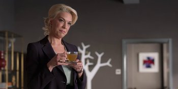 Movie still from “Ted Lasso” (2020), created by Brendan Hunt – A woman holding a cup of tea in her hands; Medium shot, Low angle