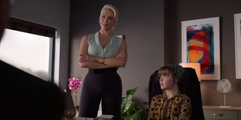Movie still from “Ted Lasso” (2020), created by Brendan Hunt – A woman standing in front of a woman sitting in a chair; Medium shot, Over the shoulder angle