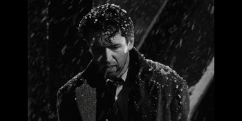 Movie still from “Ted Lasso” (2020), created by Brendan Hunt – A black and white photo of a man in the snow; Close Up shot, Low angle