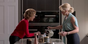 Movie still from “Ted Lasso” (2020), created by Brendan Hunt – Two women are talking over a table in a kitchen; Medium shot, Over the shoulder angle