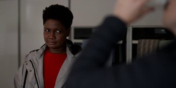 Movie still from “Ted Lasso” (2020), created by Brendan Hunt – A woman in a red shirt looking at a man in a black jacket; Close Up shot, Over the shoulder angle