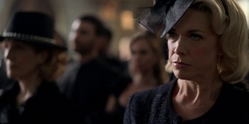 Movie still from “Ted Lasso” (2020), created by Brendan Hunt – A person wearing a hat; Close Up shot, Over the shoulder angle