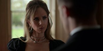 Movie still from “Ted Lasso” (2020), created by Brendan Hunt – A woman looking at a man in a suit in front of a mirror; Close Up shot, Over the shoulder angle